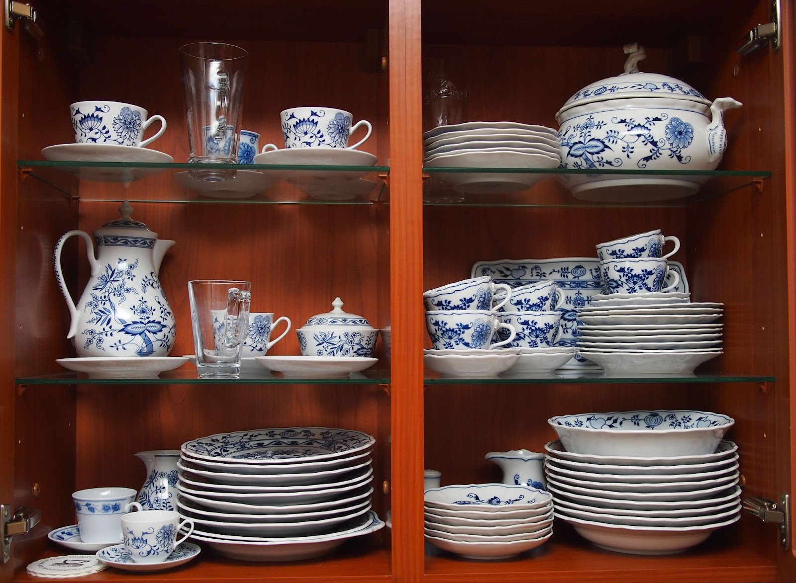 cabinet filled with blue and white china showing wedding registry tips for what you don't need